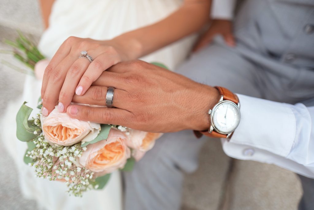 A bride and groom holding hands