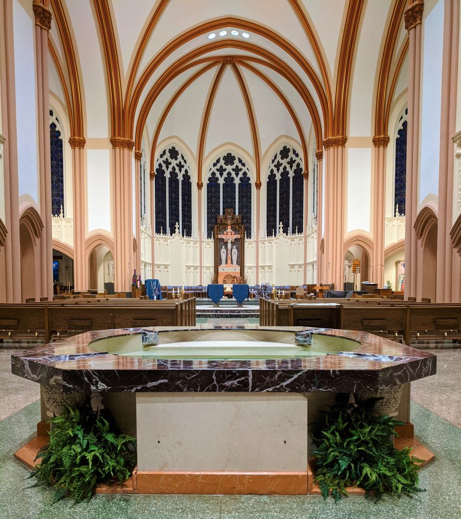 The baptismal fount. The is made out of a black marble stone.