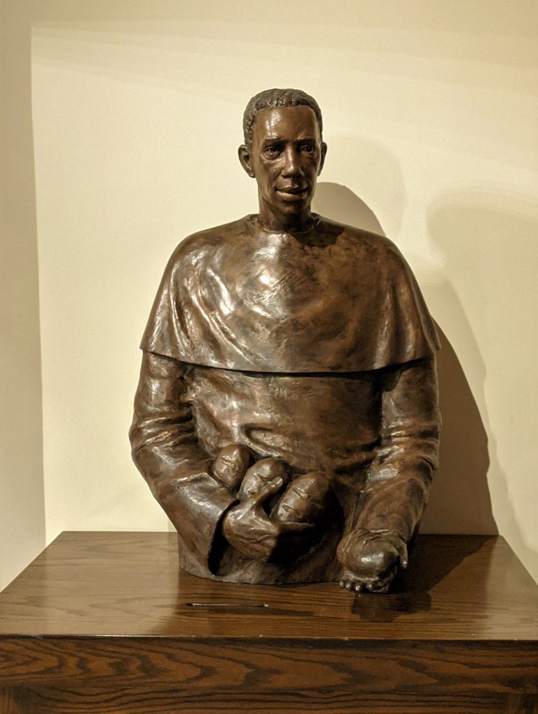 A metal statue of Saint Martin de Porres.