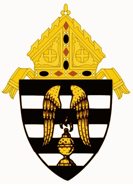 The crest of the Diocese of Gary crest which is angel wings over an incense thurible and an alternating pattern of black and white stripes. On tope of it is a golden mitre (bishop's hat)